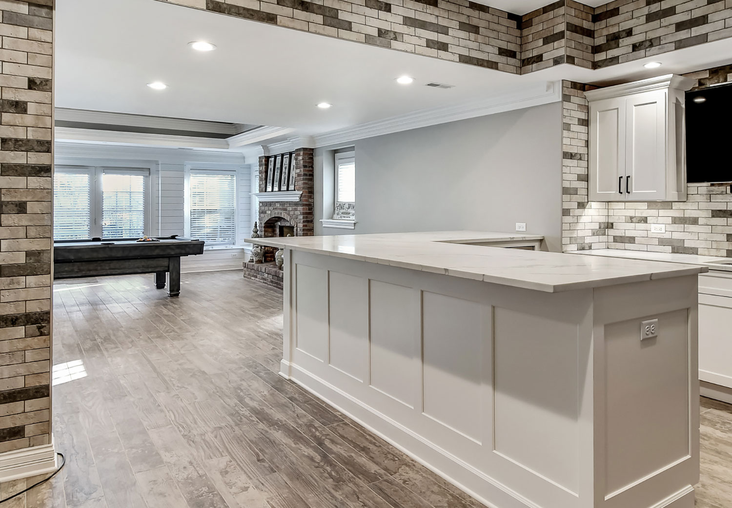 Custom kitchen island and open living area with stone accent walls in a luxury townhome in Glen Ellyn